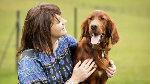Irish setter Tucker and his new owner at Kimpton adoption centre